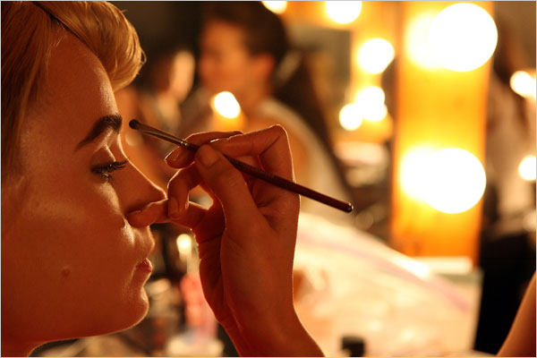 A model has makeup applied.