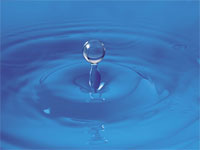 Photograph of a drop of water.