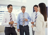 Photograph of office mates sharing a drink by George Doyle/Stockbyte/Getty Images.