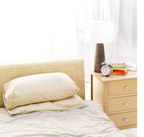 Photograph of an unmade bed by Stockbyte/Getty Images.