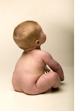 Photo of a baby boy from behind.