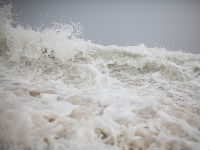 Photograph of wave caused by Hurricane Bill courtesy of Brendan Hoffman/Getty Images.