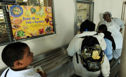 A cafeteria worker supervises lunches for school children. Click image to expand.