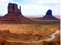 A road winds between the distinctive buttes of Monument Valley