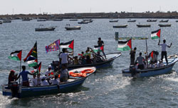 Palestinians ride on boats at the port of Gaza City during a rally in support of the Gaza-bound international Freedom Flotilla. Click image to expand.