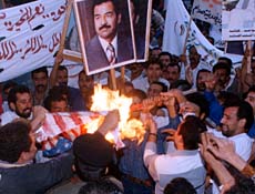 Iraqi protesters burn the U.S. flag