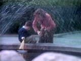 Mother and son by fountain