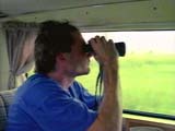 Searcher staring through binoculars