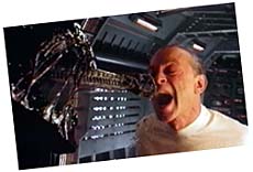 A captured alien and Gediman [Dourif)
