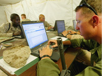 Soldier using a laptop. Photograph by Justin Sullivan/Getty Images.