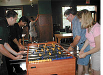 Campers playing foosball in the evening