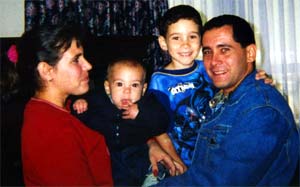 Photograph of Elian with his stepmother, half-brother, and father