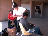 Cutting hair up under the building